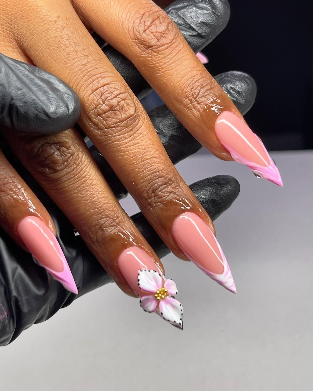 Pink stiletto nails with flower art