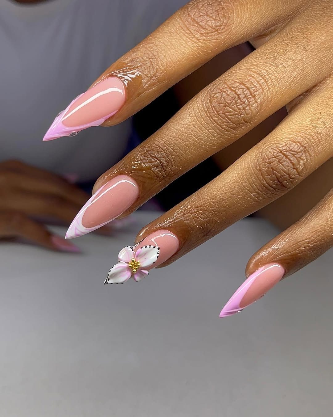 Pink long stiletto nails with flower art