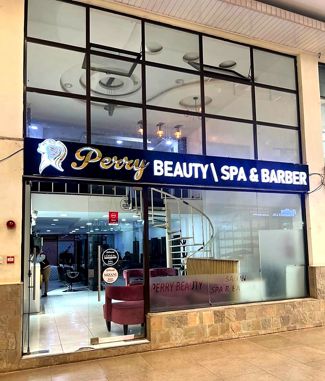 The lit Perry Beauty, Spa and Barber shopfront at Greenhouse Mall on Ngong Road